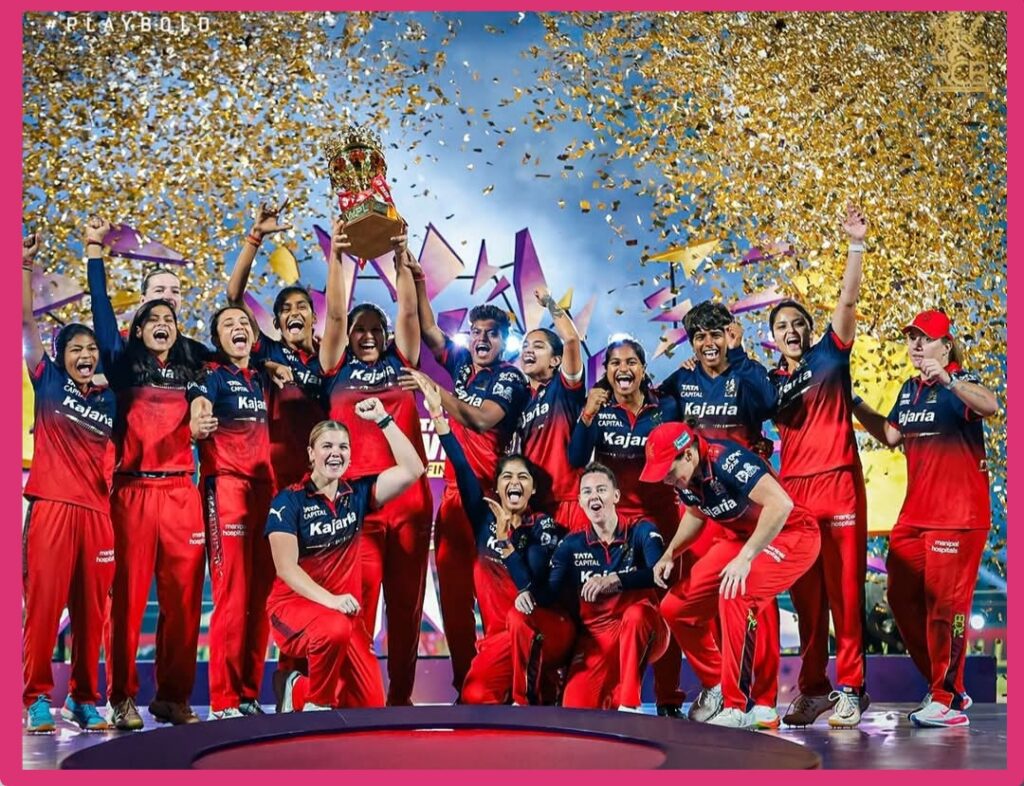 Royal Challengers Bangalore women team celebrating WPL 2026 final victory with trophy.